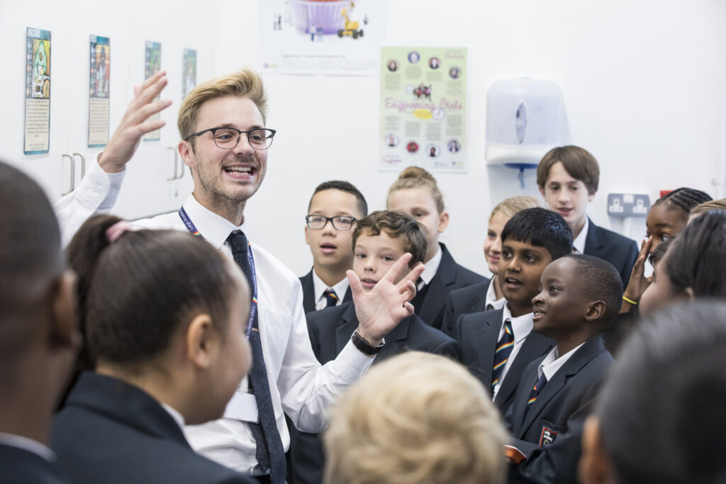 Staff member talking to students in a group