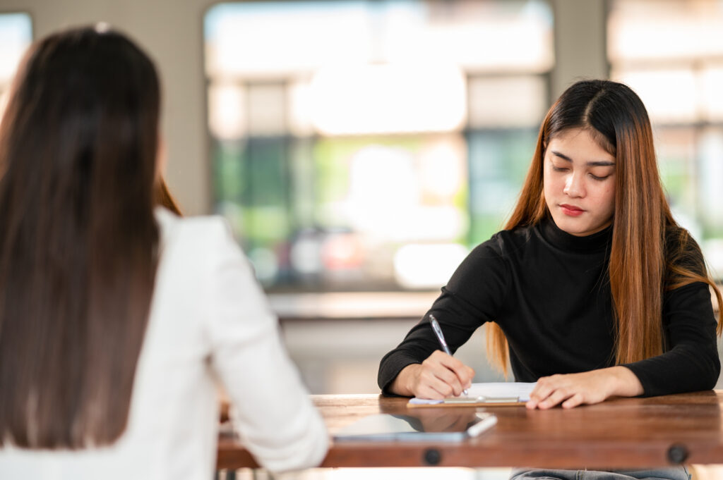 Asian female student sit for exam at university classroom students sitting in the row education lifestyle university college