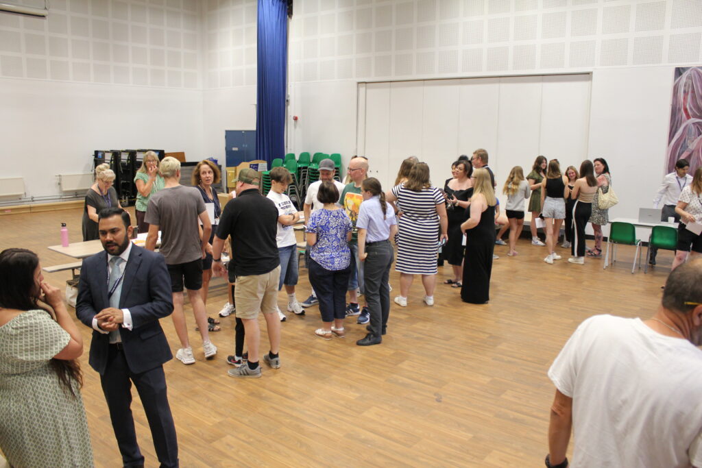 Groups of Post-16 students and their parents are pictured gathering in the main hall to receive their A-Level results.