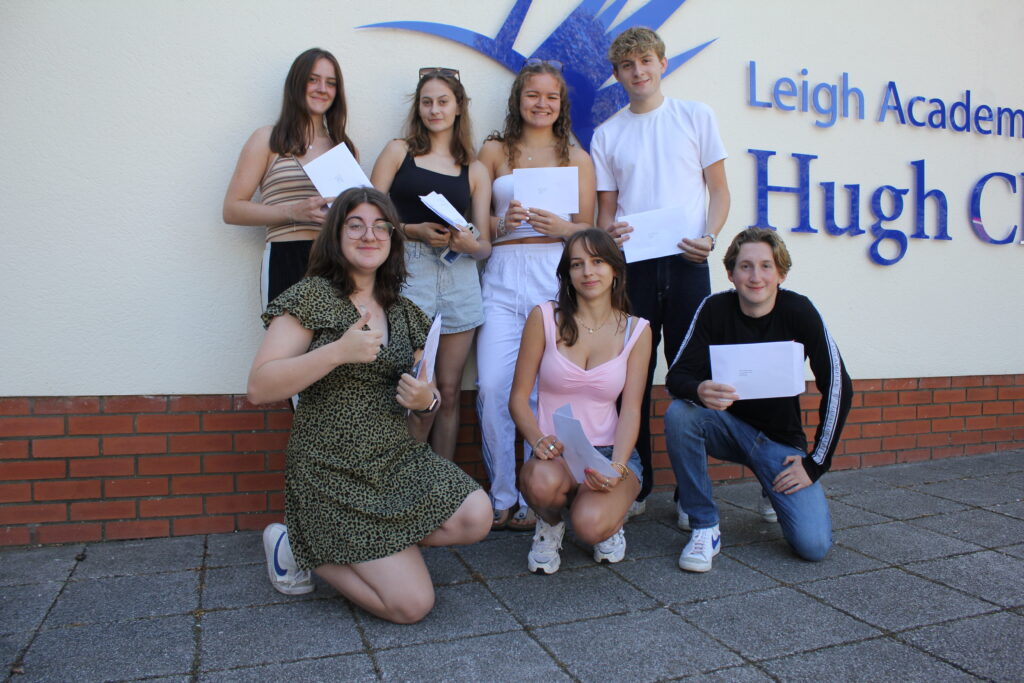 A group of seven Post-16 students are pictured smiling together outdoors, after having just opened their A-Level results.