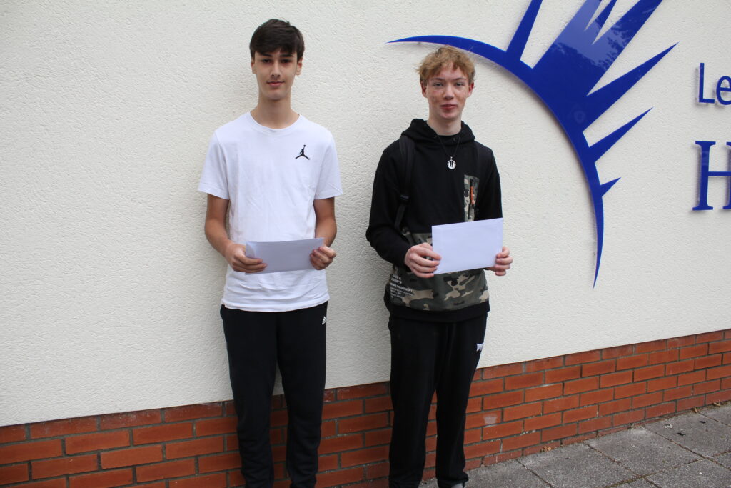 Students stood holding their results