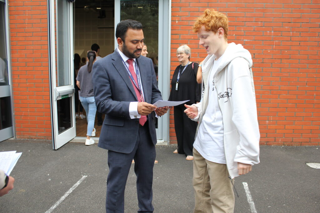 Students stood holding their results