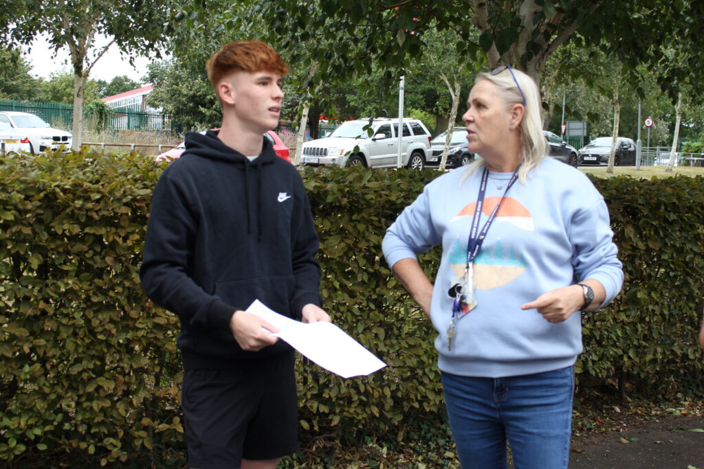 Students stood holding their results