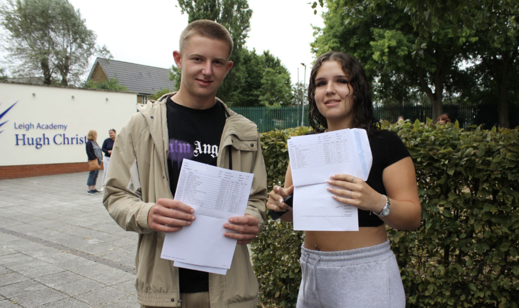 Students stood holding their results