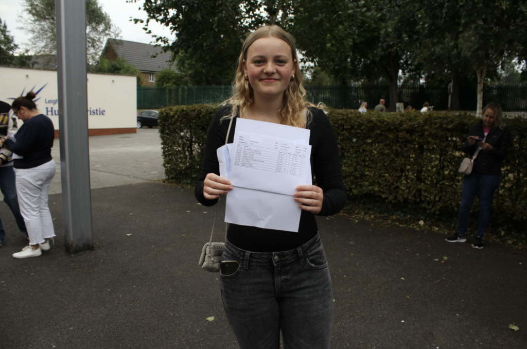 Students stood holding their results